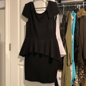 Black plus size peplum dress with petal sleeves.